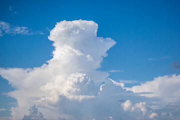 Beautiful white anime-looking clouds over a blue sky for the background.