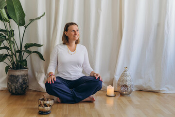 A happy woman after a breathing and singing bowl practice.