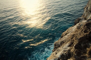 Coastal Cliffside with Sunlight Reflecting on the Ocean Waves