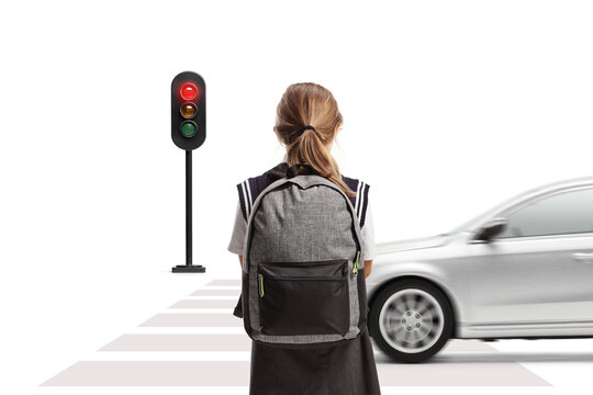 Child waiting to cross a street at a pedestrian crossing