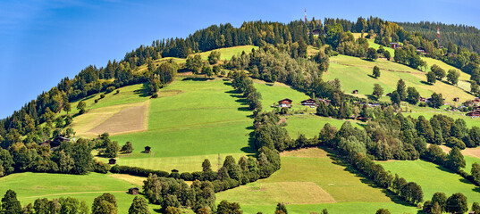 hilly farm land at the lake Zell in the region Pinzgau of Slazburg, Austria