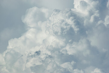 Beautiful white anime-looking clouds over a blue sky for the background.