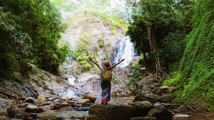 Asian women relax in the holiday. Travel waterfall On the Moutain (Huai Toh waterfall) at Krabi. travel nature, Travel relax, walking forest, Travel Thailand.