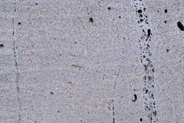 Texture of gray concrete wall with cracks. Abstract background for design.