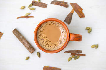 A cup of hot masala tea or masala chai in a natural clay cup. Kullad chai or clay pot tea, is a traditional way of serving masala chai. Top view.