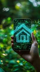 Smart home concept. Hand holding smartphone with house icon on green nature background