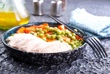 Savory vegetable stew with chicken fillet on plate on a table