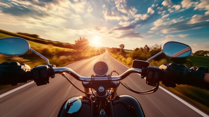 Naklejka premium A thrilling perspective from a motorcycle rider's point of view, cruising down an open road with a breathtaking sunset and picturesque scenery.