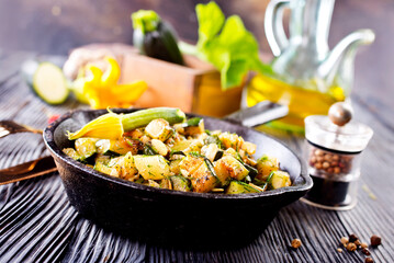 Baked vegetables in pan on a table, close up view