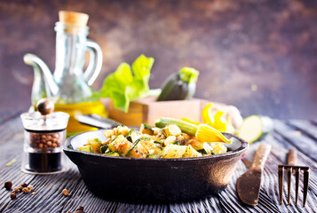 Baked vegetables in pan on a table, close up view