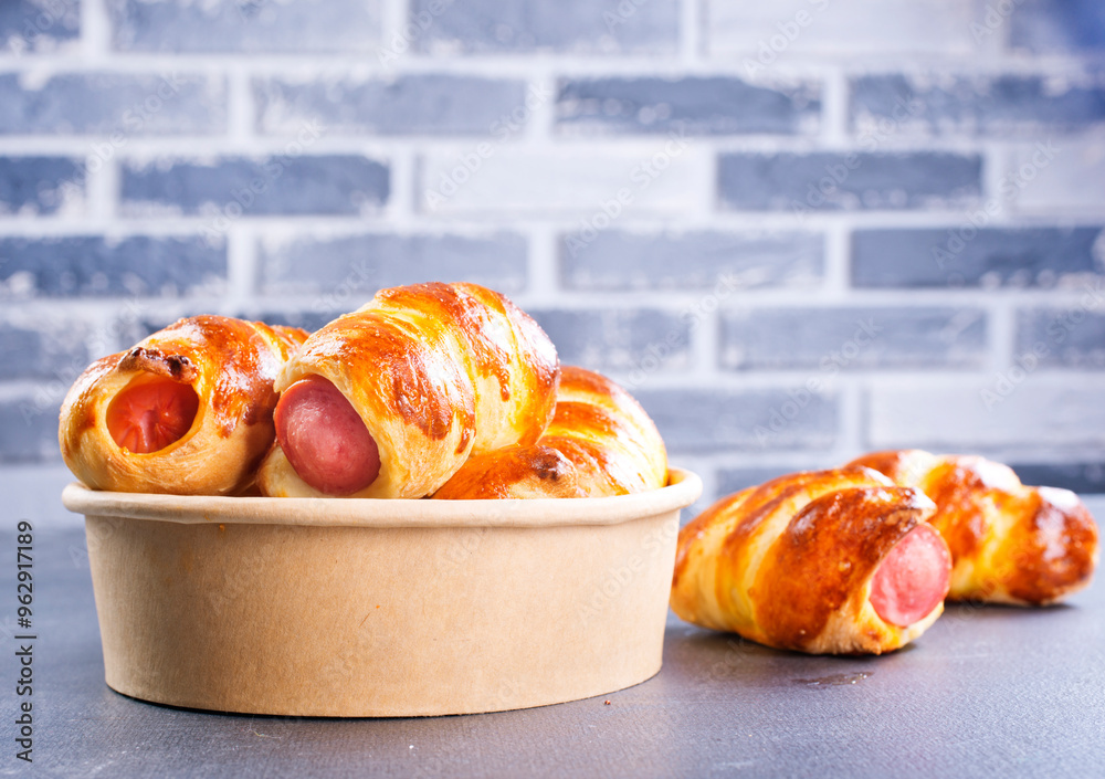 Canvas Prints Close-up of baked sausages in dough in bowl.