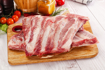 Raw pork ribs over board