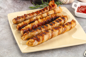 Grilled meat sausages wrapped bacon