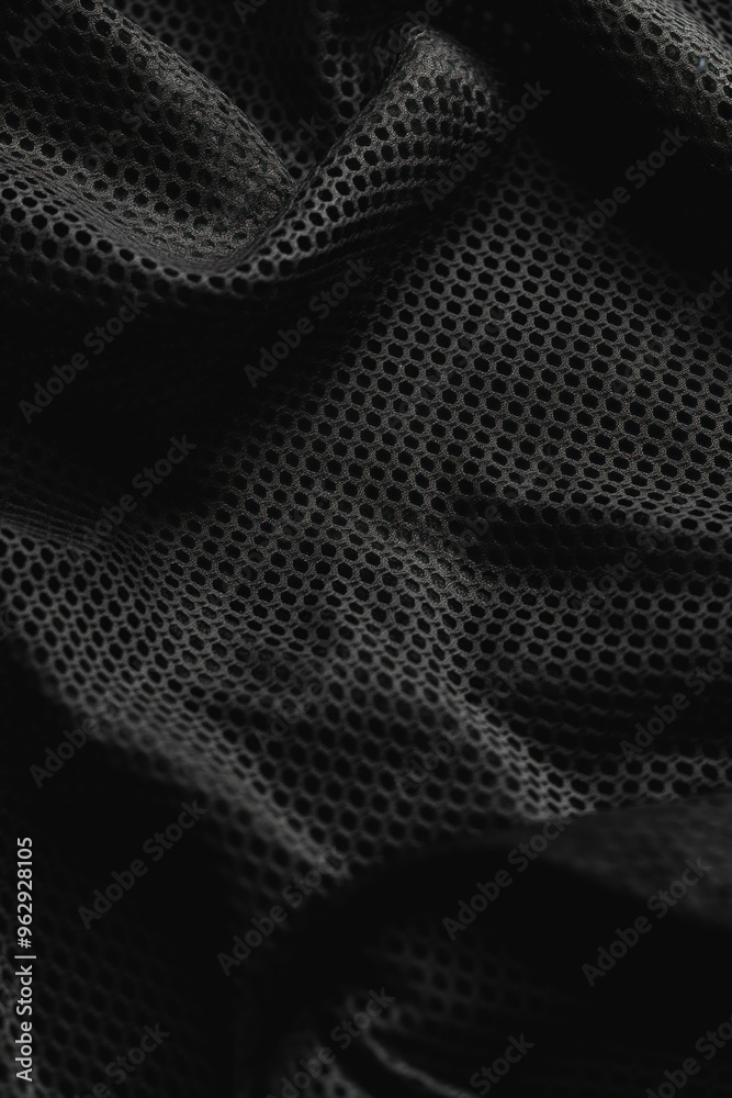 Poster Black fabric grid pattern close-up. Slightly wrinkled texture adds depth to image. Unique perspective from above. Perfect for abstract backgrounds or sports clothing designs.