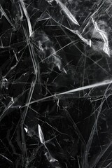 Fototapeta premium Close-up of rough black plastic film wrap texture on dark background. Crinkled plastic surface adds depth and dimension. Ideal for tech, eco, or design projects needing unique material inspiration.
