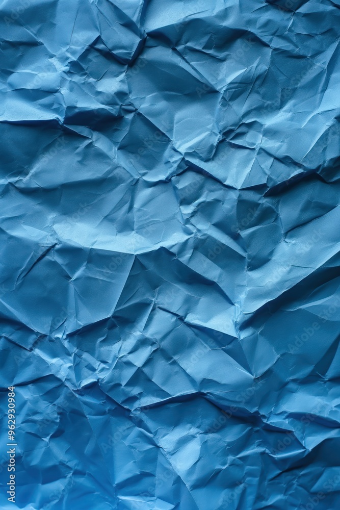 Poster crumpled blue paper texture with creased surface. close-up view of folded and wrinkled paper against