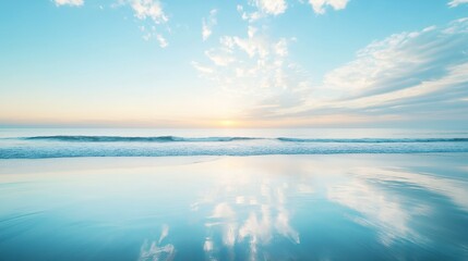 Obraz premium Calm blue ocean with white clouds reflected in the water at sunrise.