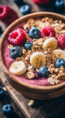 A close-up of a smoothie bowl topped with fresh fruits and nuts on a rustic wooden table
