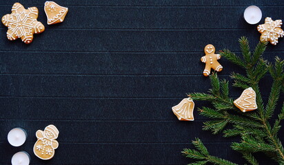 Gingerbread and Christmas tree branches on a dark paper craft background. Happy New Year Banner