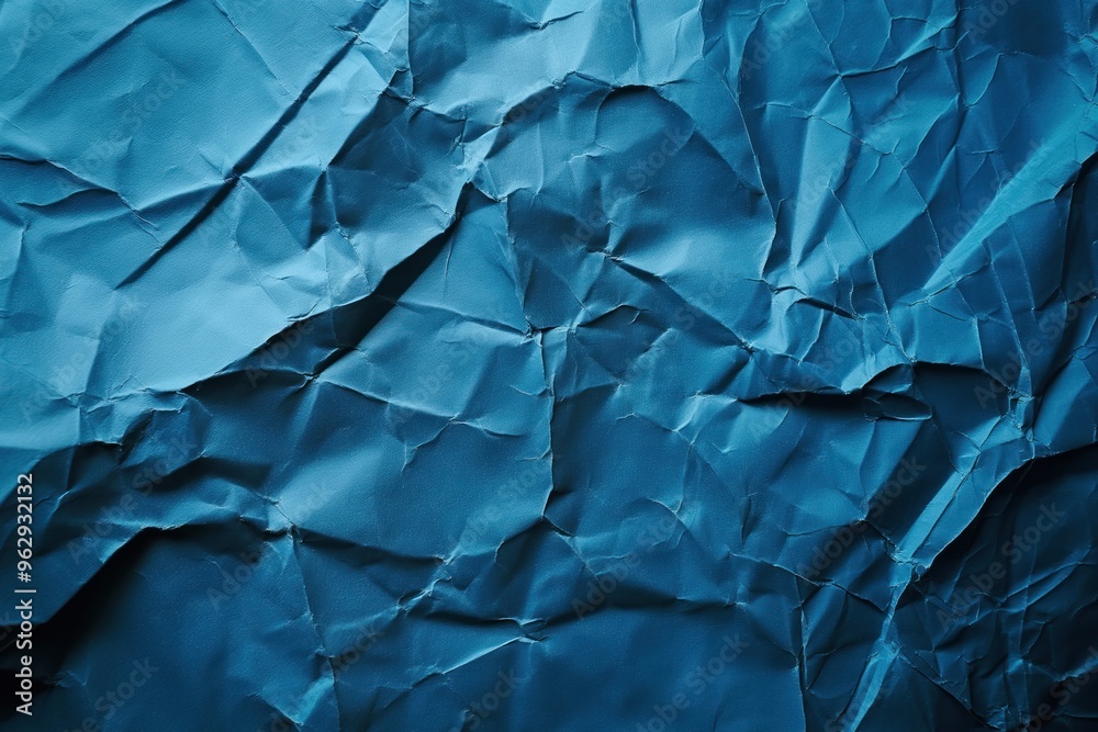 Poster Crumpled blue paper texture with rough surface. Close-up view of folded and creased paper on dark blue background. Ideal for graphic design, digital art, or as a unique background image.