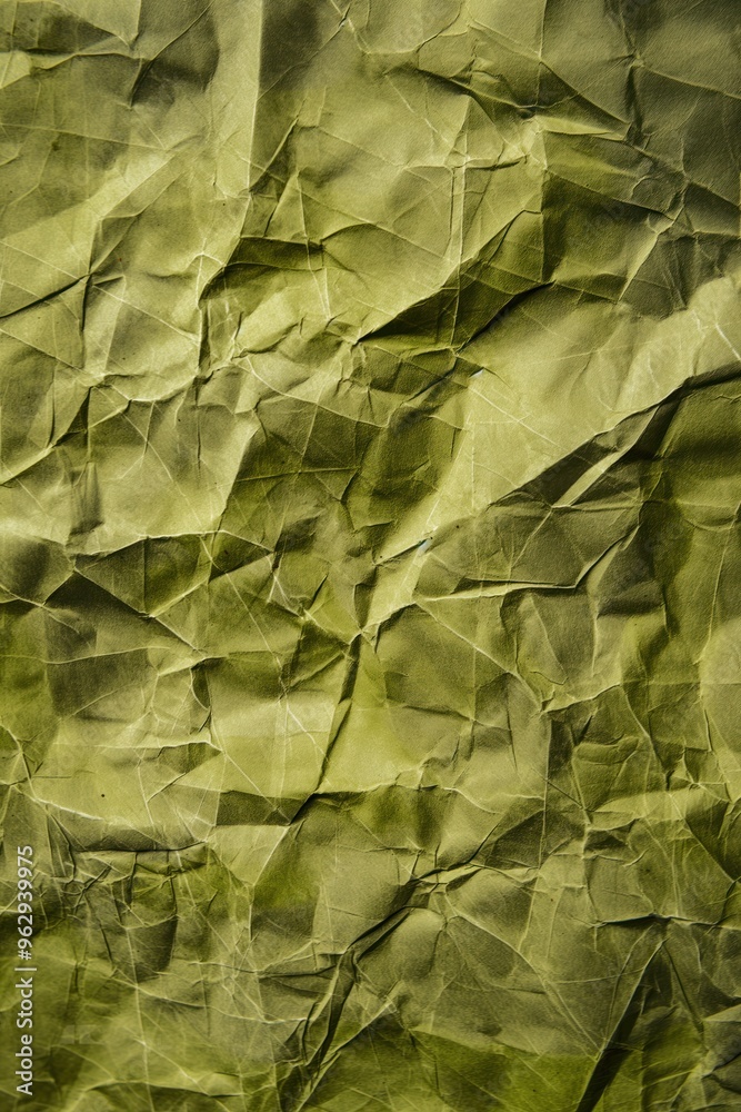 Poster olive green crumpled paper with rough texture. close-up view of folded and creased poster background