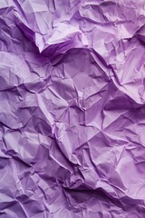 Obraz premium Crumpled purple paper texture with intricate folds. Close-up view of creased and curled edges. Black and white background highlights textured surface. Perfect for design, art, or creative projects.