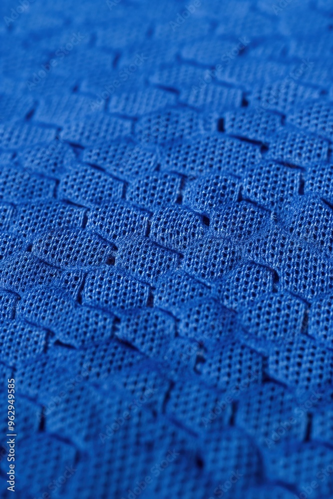 Aufkleber Close-up of blue fabric with intricate weave pattern. Unique squares vary in size and shape creating texture and depth. Focus on fabric details with blurred background.