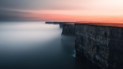 A dramatic seascape with towering cliffs against a vibrant sunset sky, shrouded in a mystical fog.