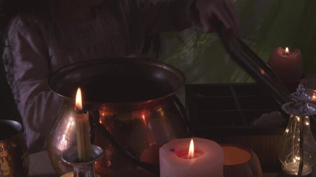 young witch stirs mystical potion in copper cauldron, adding charm to Halloween party atmosphere, magical potion, whimsical charm
