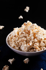 Food concept popcorn in ceramic bowl on black background with copy space