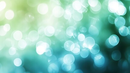 Obraz premium Soft blue and green bokeh light effects blurring gently against a neutral background, leaving space for text.
