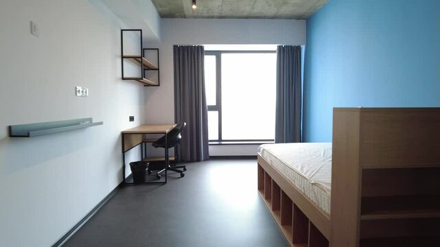 Simple student-style dorm bedroom. Hostel dormitory room. Campus