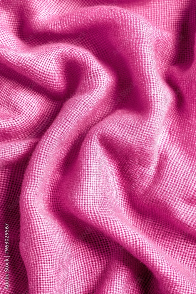 Poster Pink fabric texture pattern close-up. Crinkled pink material with small squares creating depth and dimension. Blurred background focuses on fabric. Unique perspective from slightly elevated angle.