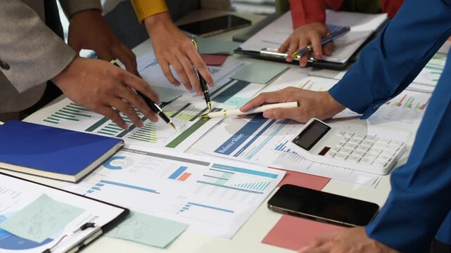 Businessmen team or financial data analysts working with tablets and laptop computers and data graphs together. Plan to analyzing projects in the office.