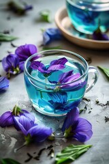 A cup of tea with purple flowers floating in it
