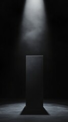 Minimalist black monolith under spotlight in dark