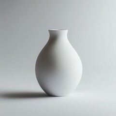 White Ceramic Vase Minimalism: A simple yet elegant white ceramic vase stands alone on a clean white background, capturing a sense of serenity and minimalist design. Its smooth curves and subtle shado