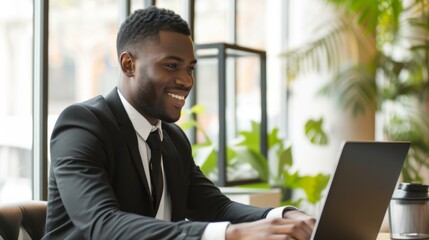 Fototapeta premium Smiling Businessman Working on Laptop in Modern Office