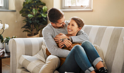 Couch, couple and hug with laugh for joke, funny memory and bonding together in marriage at home. Happy people, woman and man with love embrace for admiration, commitment or connection in living room