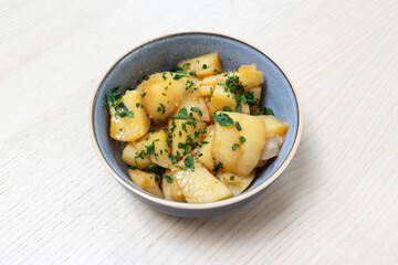 A bowl of simmered potato.