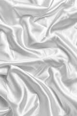 Obraz premium Close-up view of white fabric with crumpled texture, possibly clothing or decorative item. Fabric has intricate folds and creases, against simple gray background drawing attention to it.