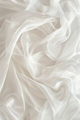 Close-up view of white fabric with subtle texture. Folded in half reveals intricate pattern. Gray background contrasts with white fabric. Fashion, textile, design projects.