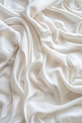 Obraz premium Close-up view of white fabric with smooth texture possibly made from cotton or linen. Fabric has slightly curled edges and blurred background drawing focus to its surface.