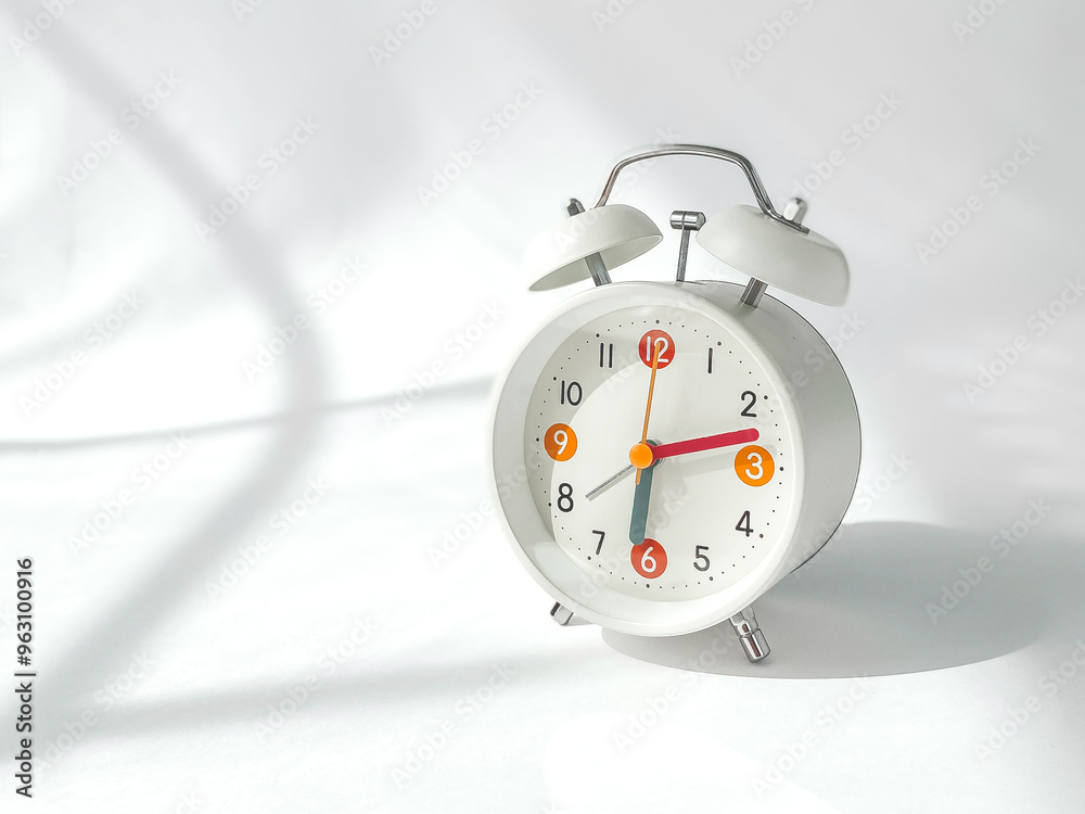 Wall mural horizontal photo of bright white round alarm clock with on white background, copyspace