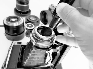 Retro camera and lens on a white background. Black and white photo.