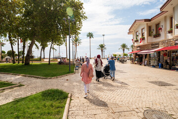 People Walking in a Scenic Coastal Town Square