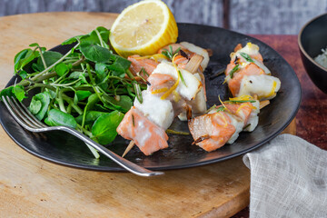 Mini salmon and halibut skewers marinated in honey, rosemary and lemon