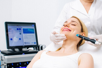 Relaxing beauty treatment in a modern cosmetic clinic. Woman enjoying a hydrolifting procedure, achieving radiant and youthful skin. Perfect for showcasing advanced skincare solutions.