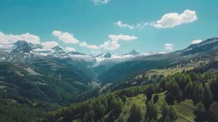 Obraz premium Majestic Drone Captured Mountain Landscape with Snow Capped Peaks and Evergreen Forests