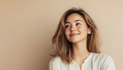 portrait of softly smiling beautiful woman is 35 years old on light beige color background, copy space, closeup